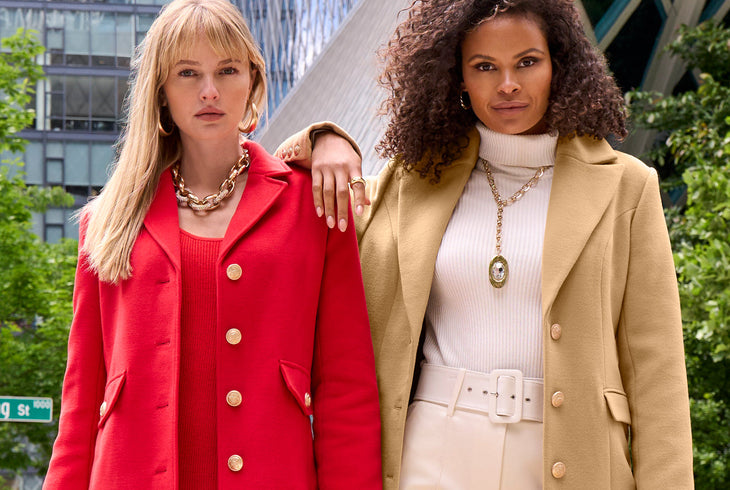 Model 1's wearing a red tailored coat with red sweater dress and model 2's wearing a white turtleneck, white ponte pants and a tan tailored coat.