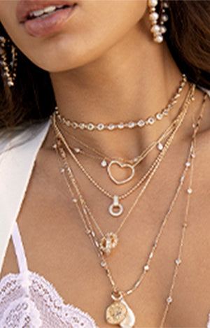 Models wearing layered necklaces