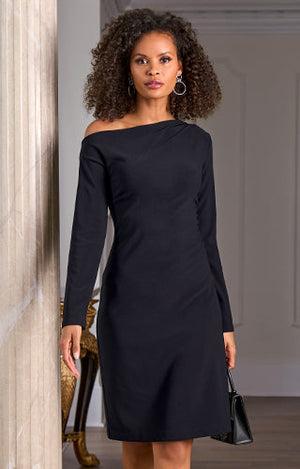 Models wearing a asymmetrical off the shoulder dress in black.