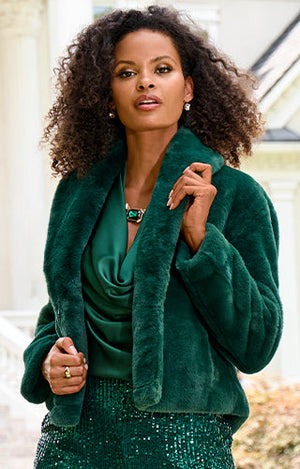 Models wearing a emarld blouse, chubby coat and emerald sequin pants.